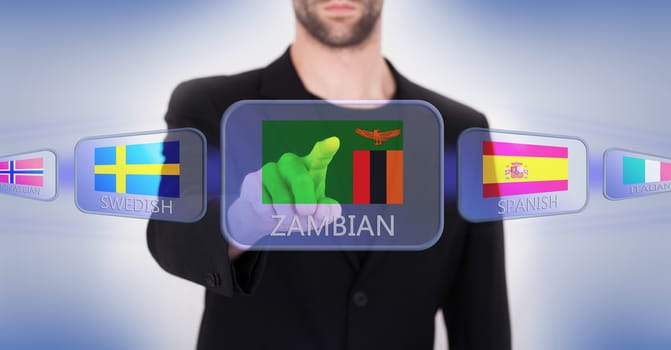 Hand pushing on a touch screen interface, choosing language or country, Zambia