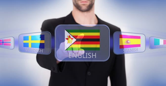 Hand pushing on a touch screen interface, choosing language or country, Zimbabwe