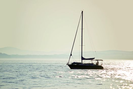 Sailboat silhouette on open water, Dalmatia, Croatia