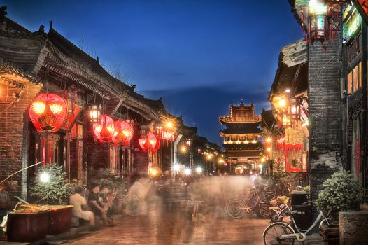 Streets of Pingyao are filled with people at night. Many shops, restaurants, bars etc.