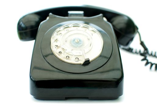 Vintage telephone over a white background