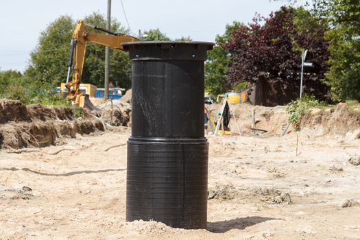 A black sewage pipe connection point in a construction site