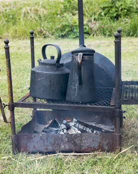 cooking on campfire with old iron pots