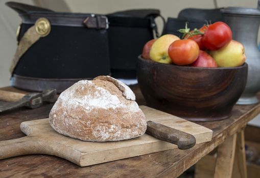 fresh bread and red tomatoes with soldiers caps on the backgrond