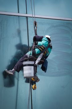 group of workers cleaning windows service on high rise building