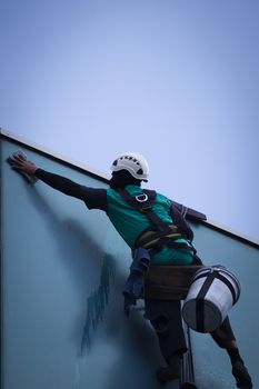 group of workers cleaning windows service on high rise building