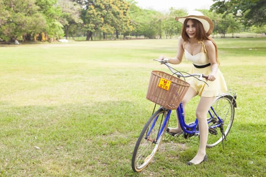 Woman riding a bicycle In the park Trees and peaceful