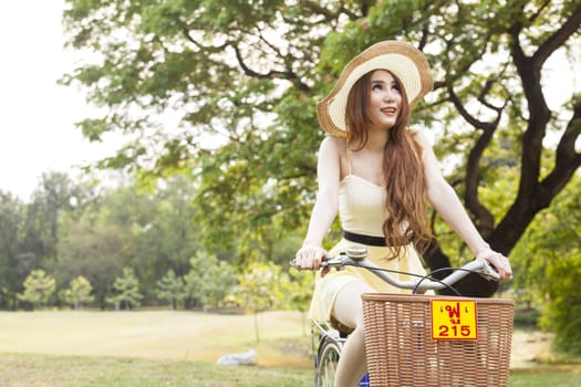 Woman riding a bicycle In the park Trees and peaceful