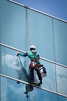 group of workers cleaning windows service on high rise building