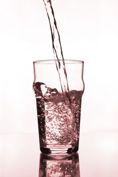 glass with water pouring on glass table