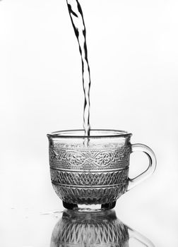 cup glass with water pouring (gray scale)