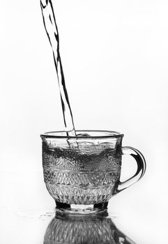 cup glass with water pouring (gray scale)