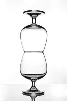 stack of empty wine glass on glass table (gray scale)