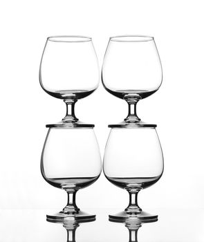 stack of empty wine glass on glass table (gray scale)