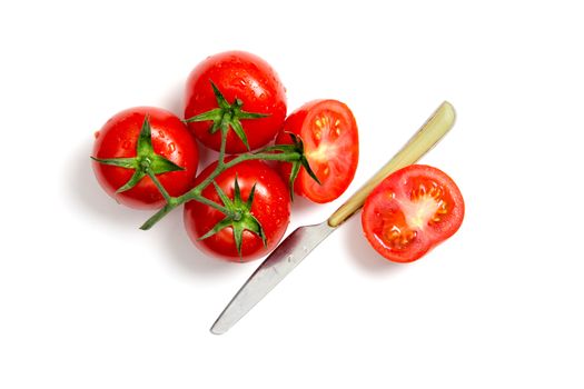 Top view of bunch of fresh tomatoes and knife isolated on white background 