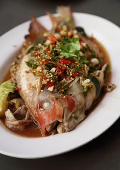 Steamed sea bass with lemon on plate