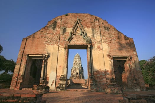 Wat Rajaburana gate and central tower in the background in Ayutthaya, Thailand.