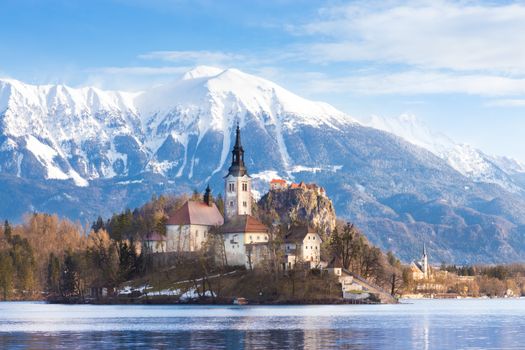 Panoramic view of Julian Alps, Lake Bled with St. Marys Church of the Assumption on the small island; Bled, Slovenia, Europe.