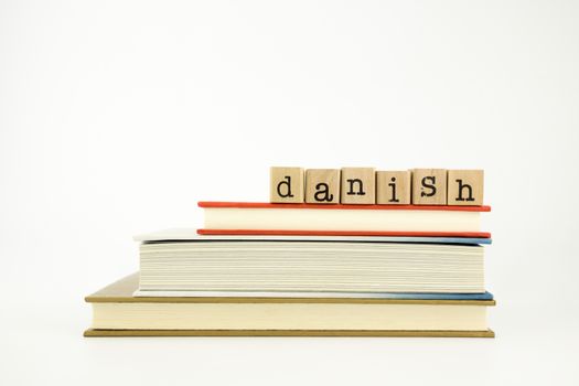 danish word on wood stamps stack on books, conversation and translation concept