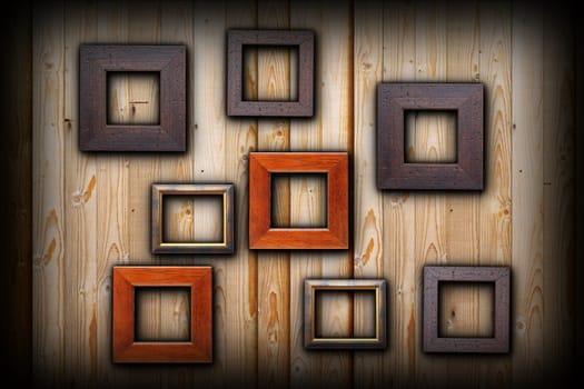 brown and beige empty picture frames hanging on wooden wall for your message