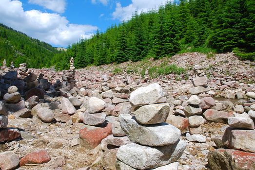 stone cairn in mountain valleys in the spruce forest