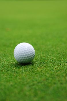 Golf ball on the green, blurred background