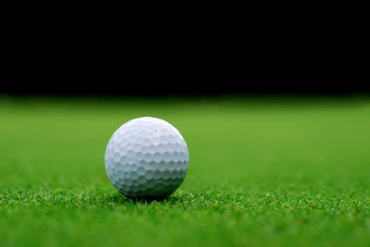 Golf ball on the green, blurred background