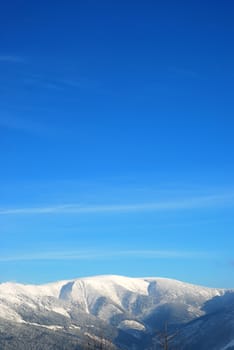 Snowy mountains under beautiful blue sky