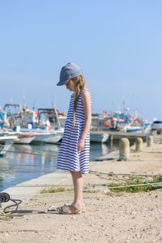 Portrait of a beautiful girl standing in harbor