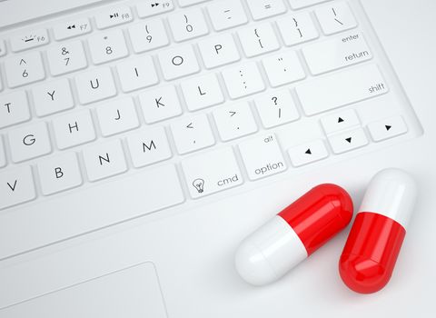 Two pills on the keyboard. View from above