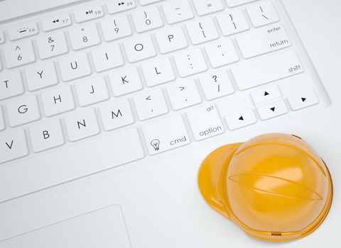 Orange helmet on the keyboard. View from above