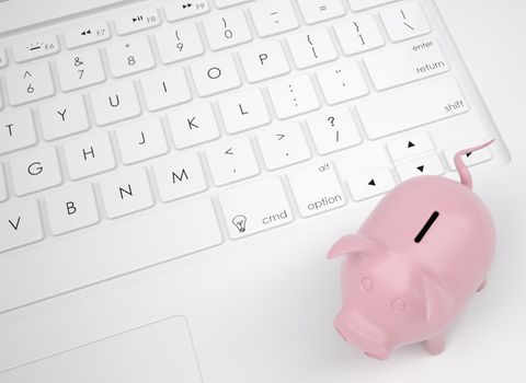 Piggy bank on the keyboard. View from above