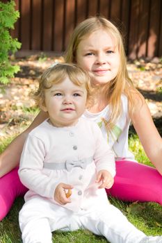 Photo of two playing girls in summer