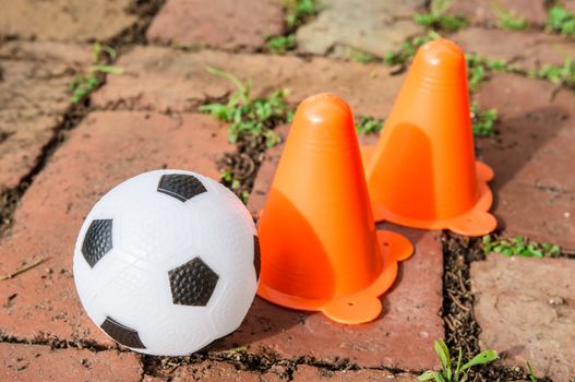 the black and white soccer ball with funnel on the ground