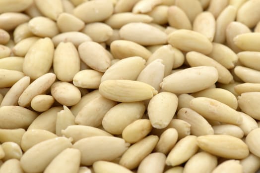 Close-up of shelled and blanched almonds kernel to use as background
