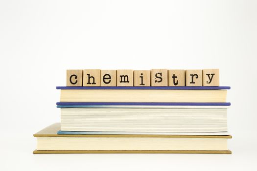 chemistry word on wood stamps stack on books, academic and study concept