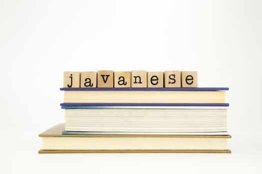 javanese word on wood stamps stack on books, academic and language concept