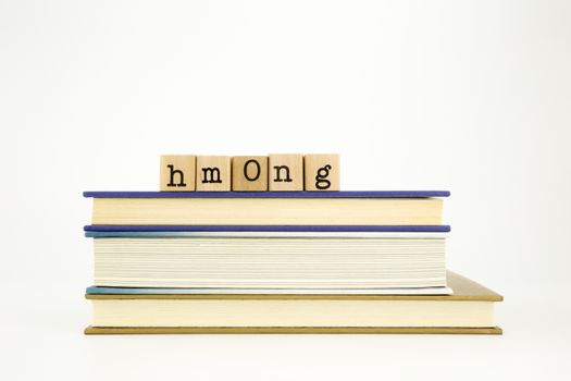 hmong word on wood stamps stack on books, academic and language concept