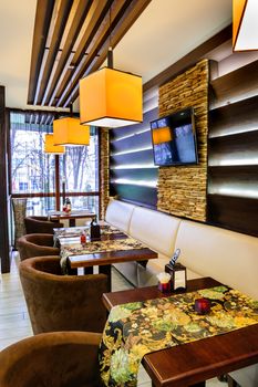 Modern restaurant interior with tables and sofas