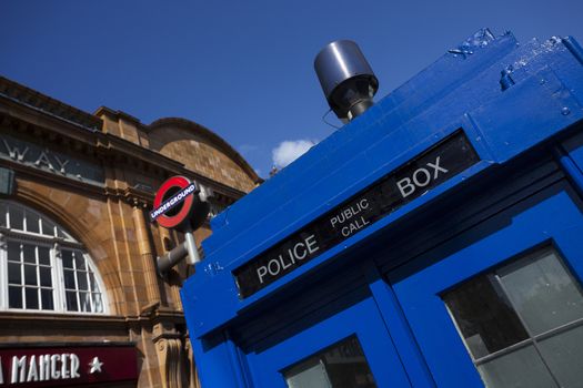 LONDON - JUNE 11, 2014: Public call police box with mounted a modern surveillance camera near Earl's Court tube station in London.