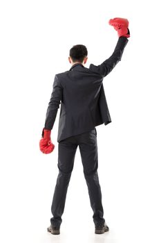 Asian businessman with boxing gloves, rear view full length portrait isolated on white background. Concept about fight, struggle, against etc.