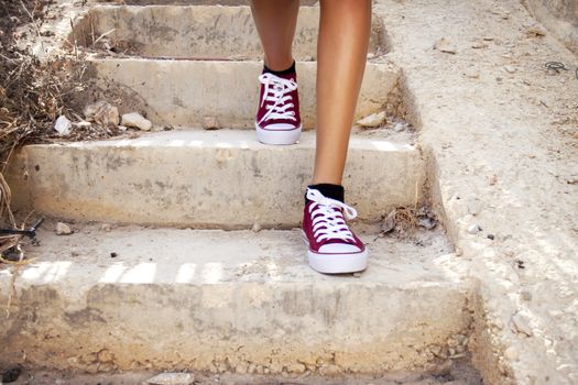 Feet with red trainers on stairs