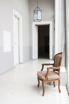 Detail of a corridor in a noble house in Malta with an armchair