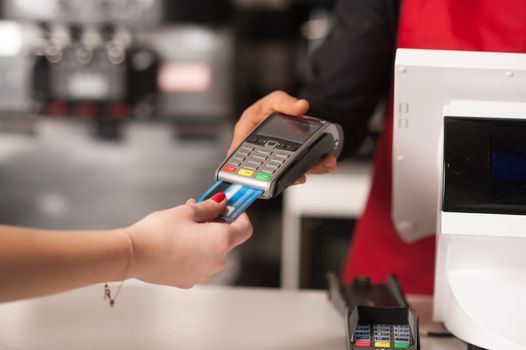 Staff receiving payment by credit card in restaurant