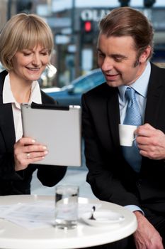 Corporate people discussing business with tablet computer