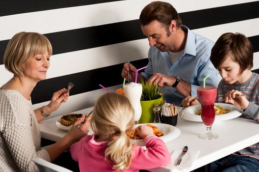 Family enjoying dinner outdoors on weekend