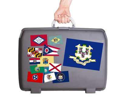 Used plastic suitcase with stains and scratches, stickers of US States, Connecticut