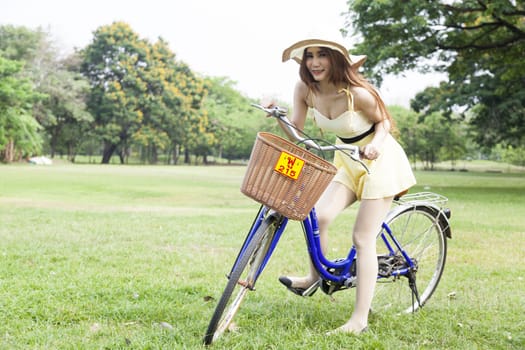 Woman riding a bicycle In the park Trees and peaceful