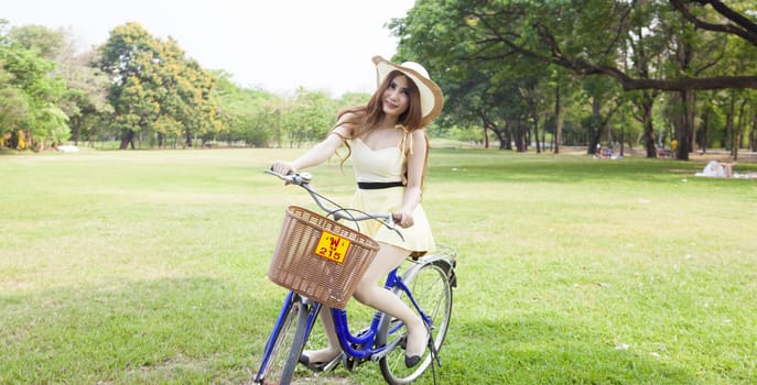 Woman riding a bicycle In the park Trees and peaceful