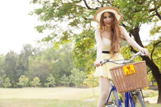 Woman riding a bicycle In the park Trees and peaceful